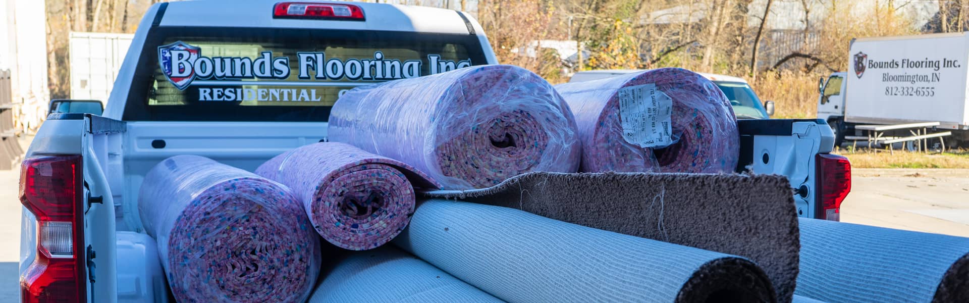Bounds Flooring Inc. truck loaded with rolls of carpet and padding.