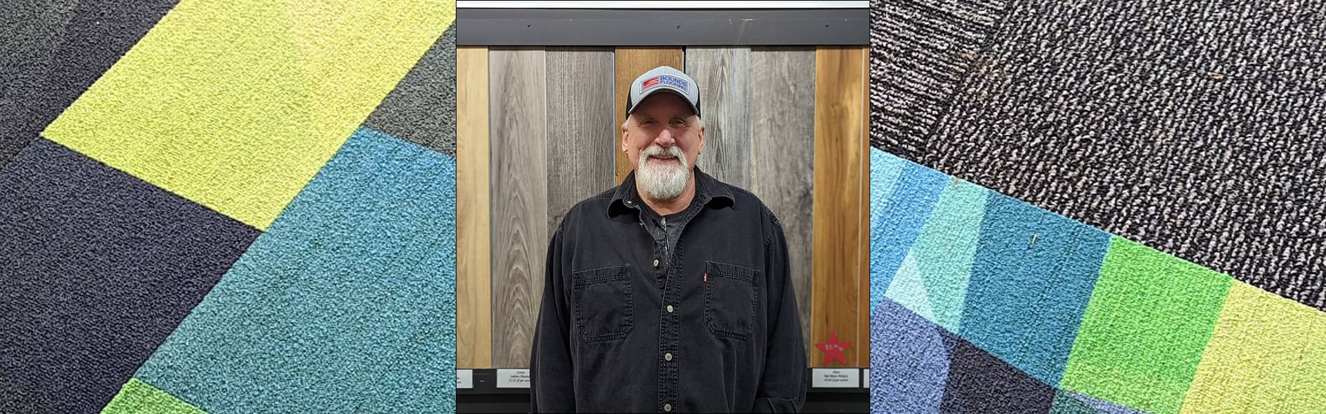 Jerry May, warehouse employee at Bounds Flooring, smiling in front of flooring samples.