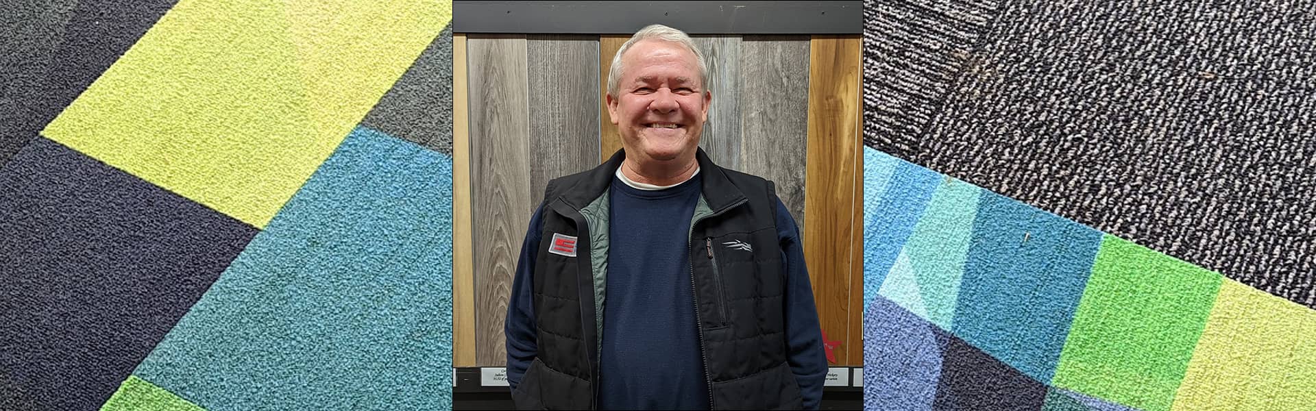 Matt McIntosh, commercial sales representative at Bounds Flooring, smiling in front of flooring samples.