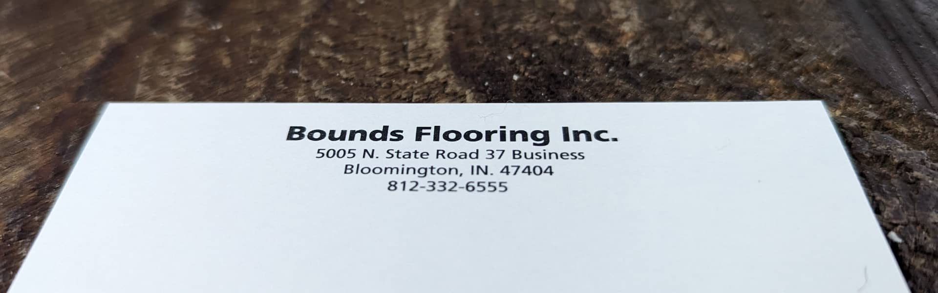 Bounds Flooring Inc. business card displaying address and contact information.