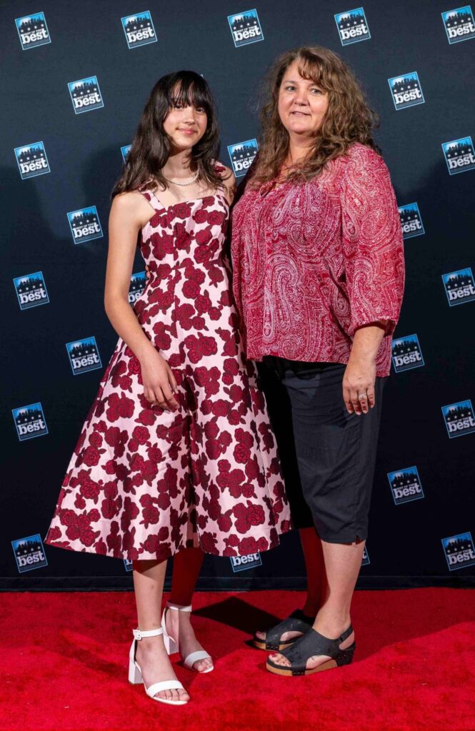 Two individuals standing on the red carpet at the Best of B-Town awards ceremony, celebrating Bounds Flooring’s 2024 win